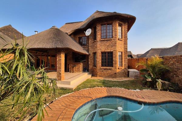 Welcome to your dream home in a secure complex with 24-hour security! This stunning double-storey face-brick house with a thatch-roof ...