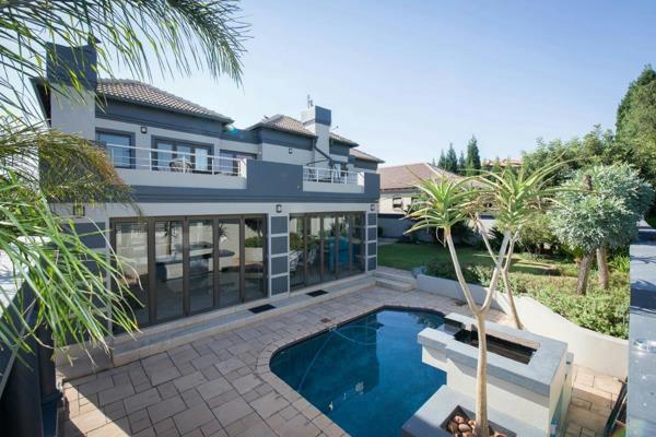 A welcoming entrance with a koi-pond and water feature. The gracious lounge area with fireplace and family room, both with sliding ...