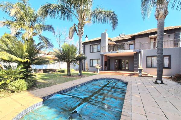 The entrance of the home features a grand double-volume staircase illuminated by a chandelier. The ground floor includes a cozy lounge ...