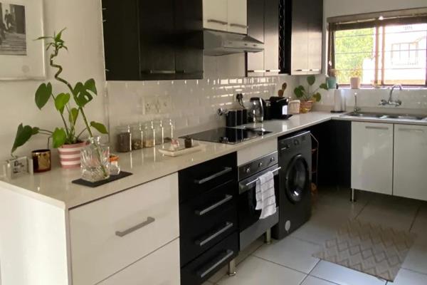 Stunning loft unit finished with a white and dark paint combination to match the two-tone modern kitchen, which is the central focal ...