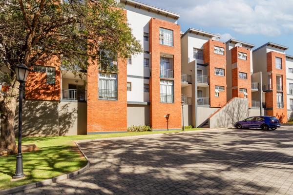 This modern  apartment offers an open plan kitchen with a lounge leading to a covered ...