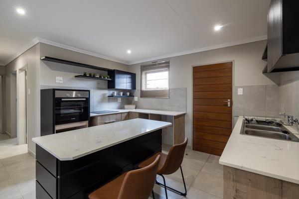 A house to dream for! A modern open plan kitchen with stone counter tops, space for a washing machine, a dishwasher, double door fridge ...