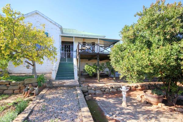 This property features a charming sandstone main house and a separate flatlet, each ...