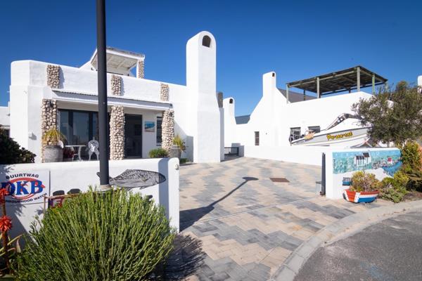 This exquisite West Coast style home, with it&#39;s striking white walls and black roof ...