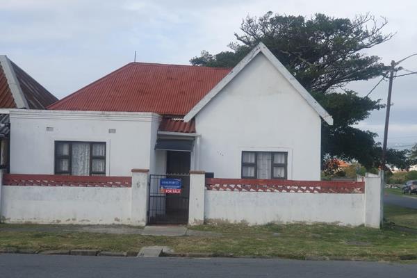 This older wood and iron home in the seaside village of Westbank, near the harbor ...