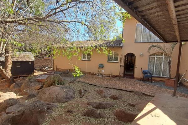 A family home in Glenvista surrounded by a rock garden to make you feel that you are ...