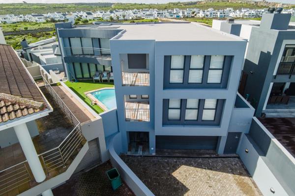 This stunning 3-storey home in the prestigious Calypso Beach offers luxury with ocean views.
Ground Floor: As you enter the house, a ...