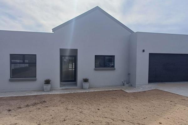 Welcome to your dream home! This newly built, modern house is situated in the highly sought-after Rheebok Estate, near Groot ...