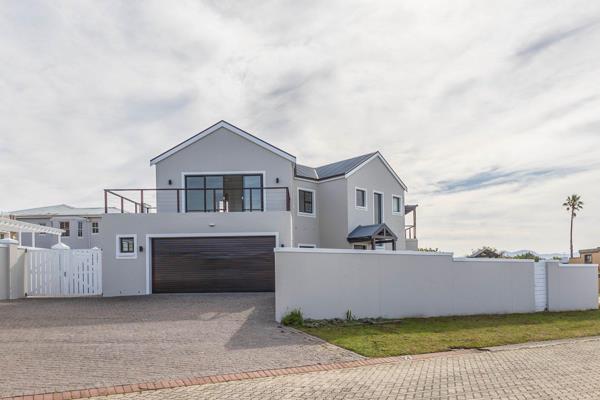 We are delighted to present this inviting family home, centrally located in a secure gated estate, just minutes from the beaches, shops, and various amenities. Joint Mandate.

The home features a spacious open-plan lounge with a cozy fireplace, a dining area, and a ...