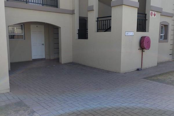 Neatly tiled. Open-plan lounge opening onto balcony. Modern kitchen with double sink, breakfast counter, granite tops, under-counter ...