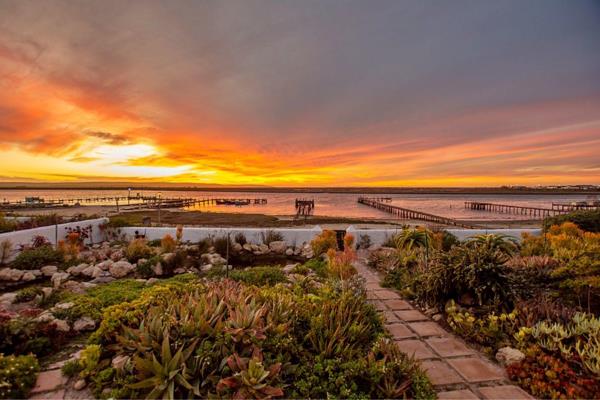 Embrace riverside living with this exceptional property. This beautiful waterfront home ...