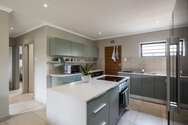 A house to dream for! A modern open plan kitchen with stone counter tops, space for a washing machine, a dishwasher, double door fridge ...