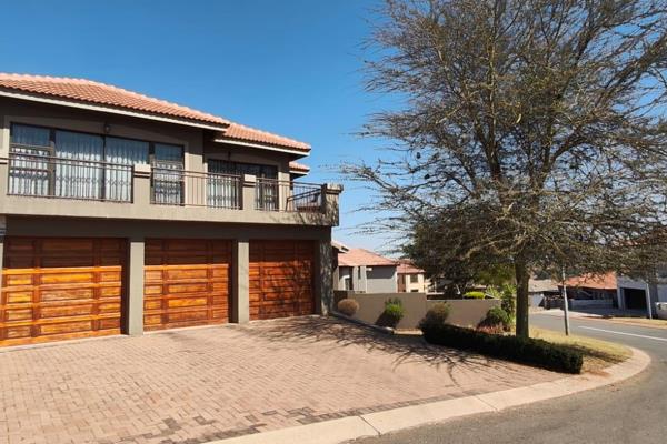 Situated in an exclusive 24-hour security estate, this property boasts comfort and style.

Walk through the double-volume entrance ...