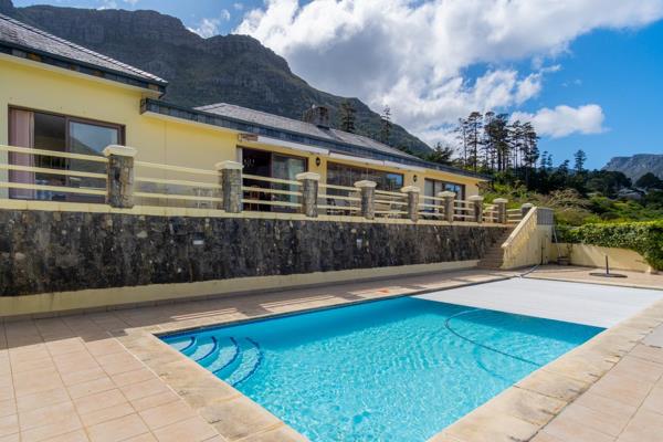 This solidly built family home located at the end of a panhandle is nestled in the prestigious Kenrock Country Estate, on the foothills of Table Mountain in Hout Bay, offering magnificent vistas of the valley and mountain ridge ...