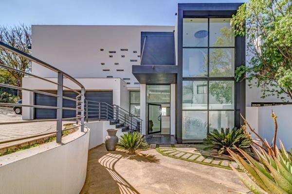 Experience refined elegance and modern sophistication in this distinguished four bedroom home, nestled on a prime corner stand within ...