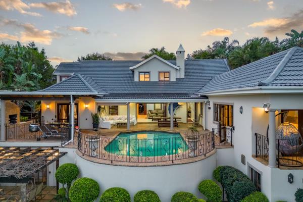 This luxurious, La Lucia home, offers a blend of comfort, style, and seamless flow. The entrance showcases a bridge over a koi pond and ...