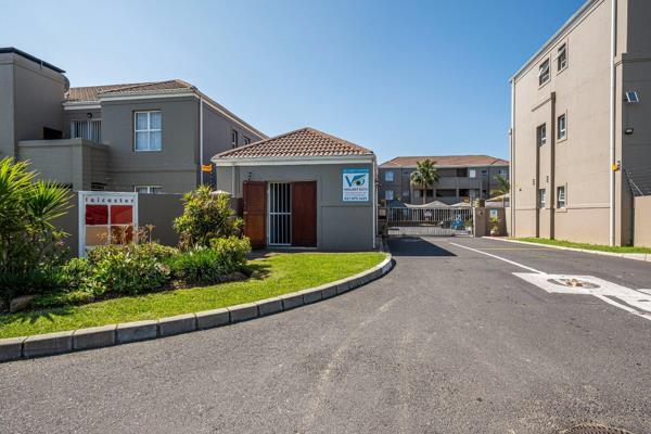 Open plan kitchen and lounge area: All tiled. 
Lounge door with security gate leads to ...