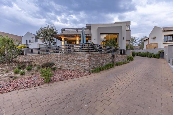 Discover contemporary elegance in this sleek home located in the prestigious Boardwalk ...