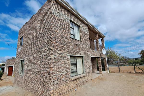 This double-story home offers 5 bedrooms, with one upstairs bedroom featuring a balcony with views. 
The main house includes 2 ...