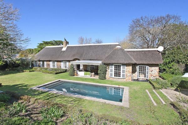 The home’s distinctive charm is highlighted by its use of timeless Table Mountain sandstone, creating a warm and inviting ambiance. ...