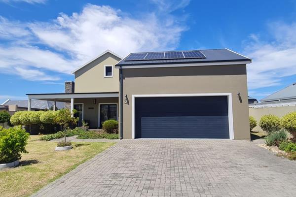 This property welcomes you with a wooden deck surrounded by a pristine garden. Upon entry, the high ceilings with exposed trusses ...