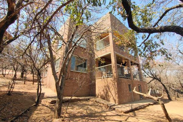 Nestled in the heart of Leeupoort, Thabazimbi, this stunning double-story face-brick home offers a serene escape with breathtaking ...