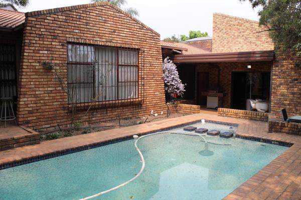 This low-maintenance face brick home offers modern living in the sought-after, secure ...