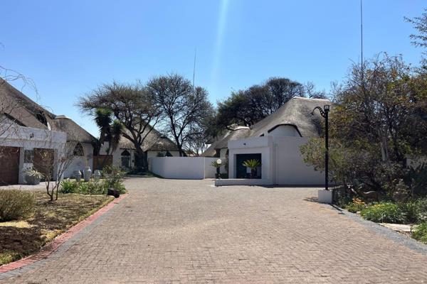 This beautiful thatch roof property offers:
Upstairs:  Main bedroom with built-in cupboards.
En suite bathroom.
Extra room for study /pajama lounge
Down stairs:  Two bedrooms with built-in cupboards.
2 x bathrooms of which one bathroom is en suite.
Living and dining ...