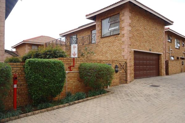 This standalone townhouse offers an inviting open-plan layout that includes a lounge ...