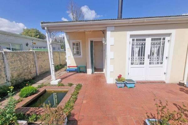 This cute 2 bed semi detached dwelling offers the following:

Private front courtyard with big built in braai, koi pond.

Good size ...