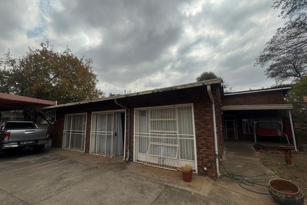 Property for sale in Protea Park, Rustenburg. The main house offers a well-equipped kitchen with a separate laundry room featuring ...