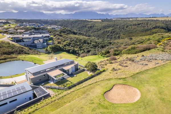 Nestled in the prominent Oubaai Golf Estate, this stunning contemporary home offers an unparalleled living experience with a seamless ...