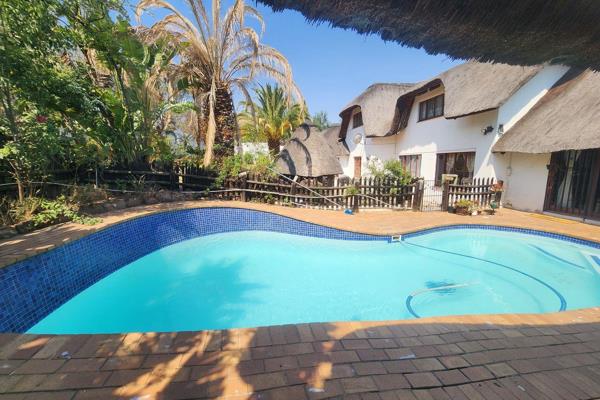 Nestled on the coveted Crawford Drive in Douglasdale, this charming thatch-roof home ...