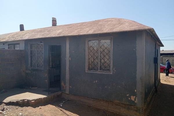 RDP house with dining, kitchen, bathroom and an outside toilet.