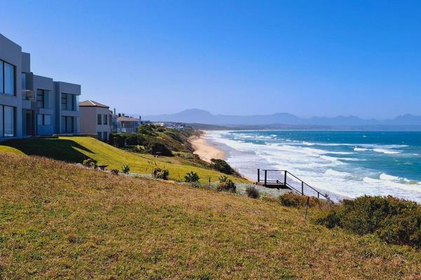 This charming 4-bedroom beach house in the highly sought-after Bay View, Hartenbos, sits directly on the beach, offering breathtaking ...