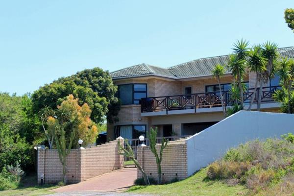 Situated within the secure Umdoni Downs estate in Port Alfred, this four-bedroom ...