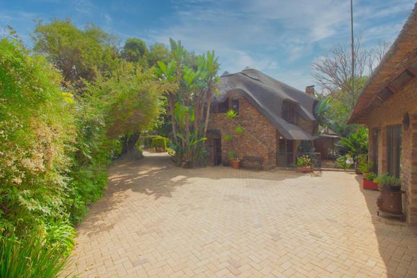 Nestled within a secure, gated cul-de-sac, this enchanting thatch home offers a unique ...