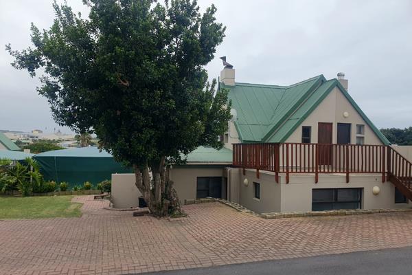 Free standing home with an open plan living area and kitchen - including an indoor braai - that opens to the outside with sliding ...