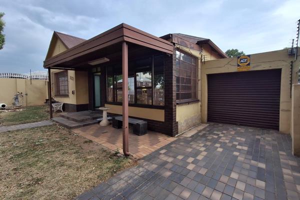 This beautiful home features a fully tiled sunroom/veranda with aluminum sliding doors ...