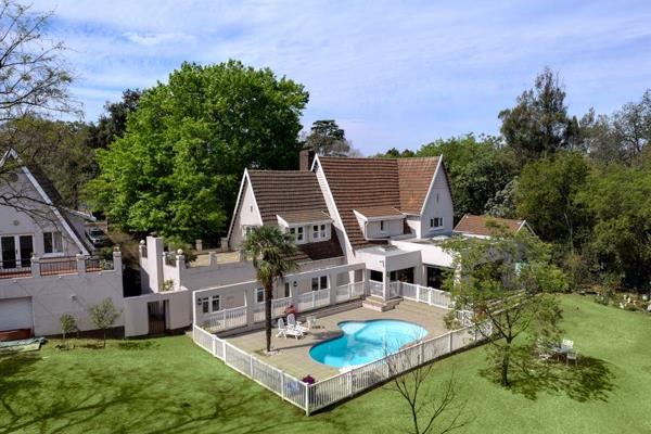 Set within a secure boomed enclave in Bryanston East on a treed acre of borehole irrigated surrounds, this charming family home offers ...