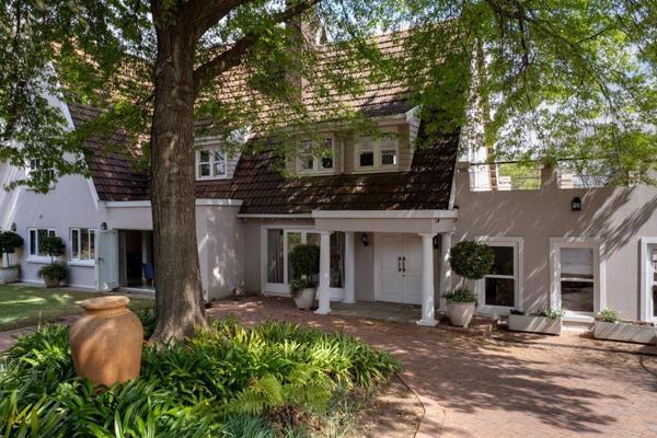 Set within a secure boomed enclave in Bryanston East on a treed acre of borehole irrigated surrounds, this charming family home offers ...