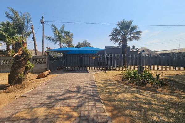 The house has a modest, welcoming appearance with a sloped roof and a single-story ...