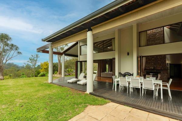 Just spectacular soaring 20 foot beamed ceilings grace the living spaces of this home ...