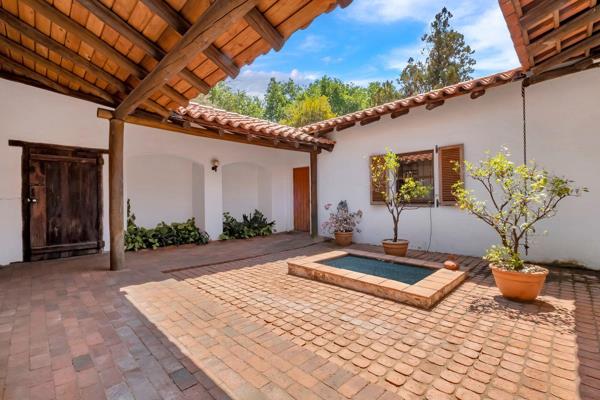 The home is a charming Spanish hacienda-style property located in the desirable Parktown North, set towards the back of a generous 1464 ...