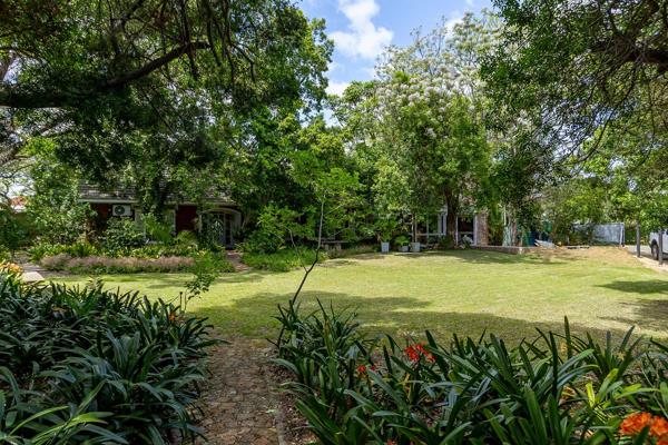 Situated on a corner plot surrounded by beautiful trees and a lush established garden, this home offers complete privacy with a ...