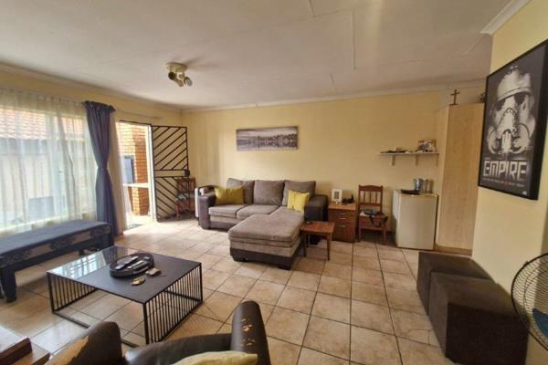 This two-bedroom townhouse boasts a private garden, built-in braai, a secure lock-up garage, and extra parking space. It offers a full ...