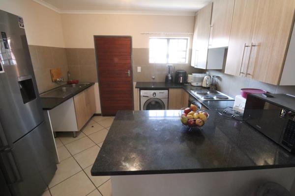 Gorgeous kitchen with lots of cupboard space, a stove with oven, dual sinks, and space ...