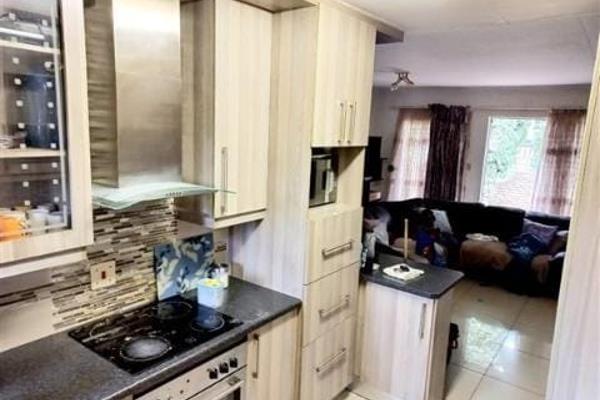 Open plan kitchen and lounge - tiled

3 spacious bedrooms with laminated wooden ...