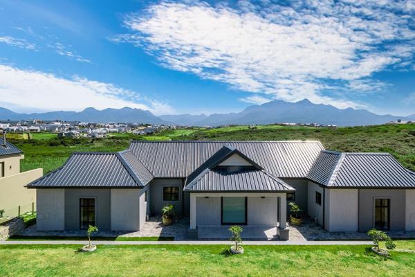 Upon entering, you will be greeted by a spacious open-plan living experience, framed by the breathtaking Outeniqua Mountains, a ...