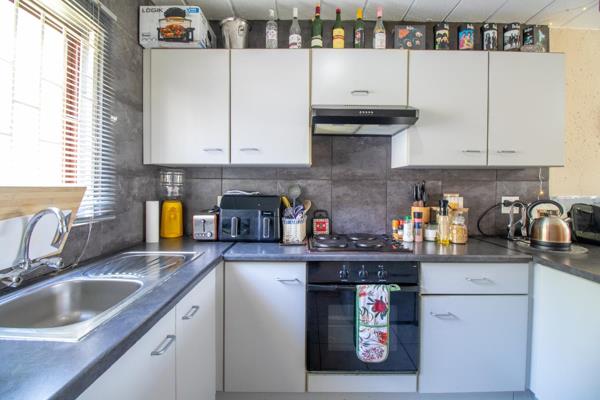 The kitchen has loads of cupboards and ample working space and is fitted with an under counter oven and stove top. There is also a ...